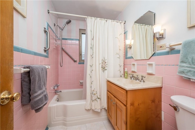 bathroom with vanity, shower / tub combo, tile walls, toilet, and tile patterned floors