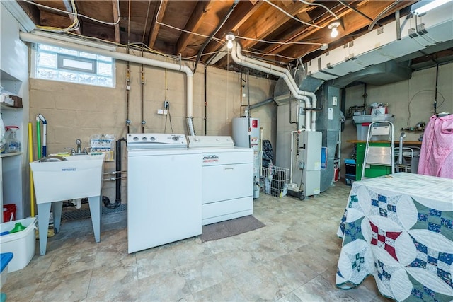 below grade area with heating unit, gas water heater, and separate washer and dryer