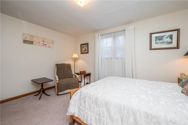 bedroom featuring baseboards and light carpet