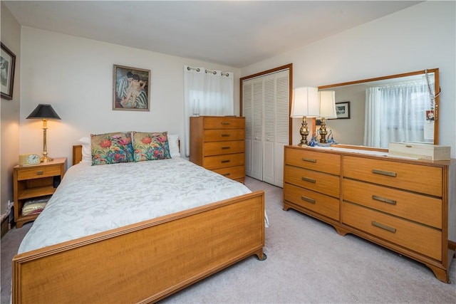 bedroom featuring light carpet and a closet