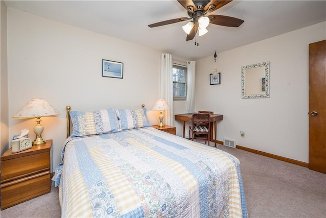 carpeted bedroom with baseboards, visible vents, and ceiling fan