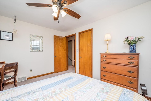 carpeted bedroom featuring visible vents, ceiling fan, and baseboards