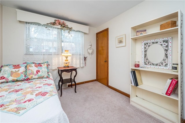 bedroom with light carpet and baseboards