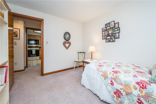 bedroom with baseboards and light carpet