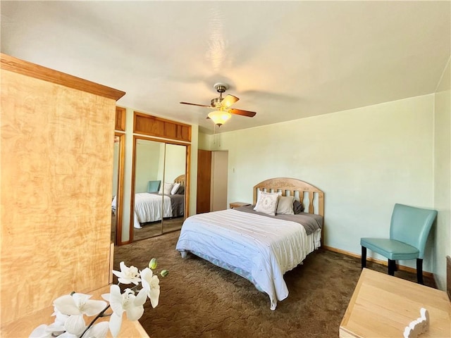 carpeted bedroom featuring a closet, baseboards, and ceiling fan