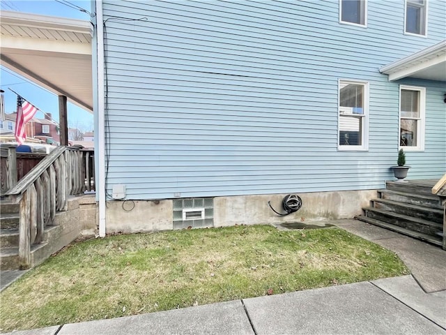 view of side of property featuring a lawn and fence