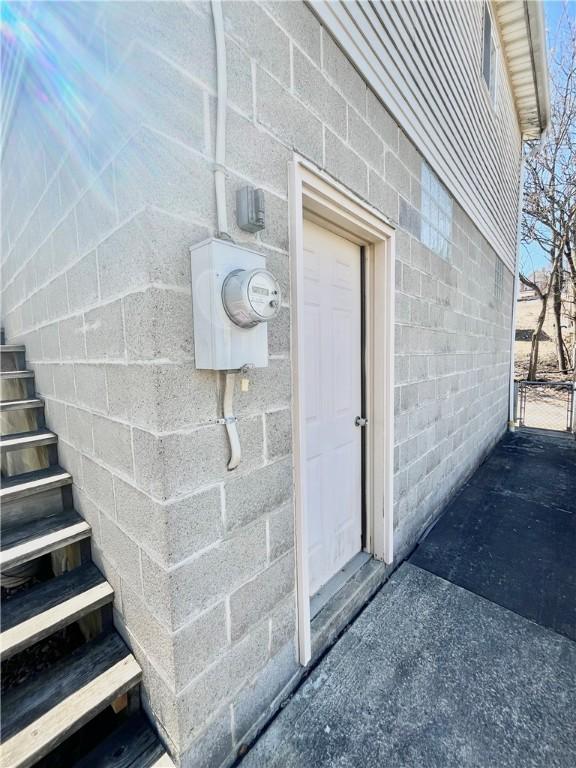 doorway to property featuring concrete block siding