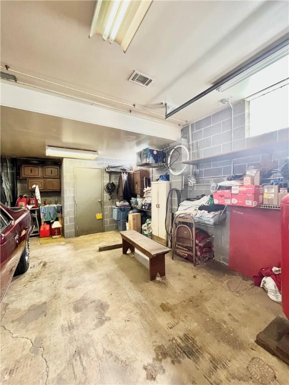 garage featuring visible vents and concrete block wall