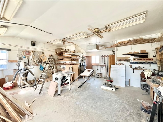 garage with a workshop area and ceiling fan