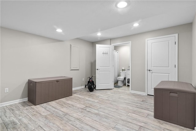 interior space with light wood finished floors, recessed lighting, and baseboards