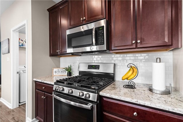 kitchen with light stone counters, decorative backsplash, light wood-style flooring, and appliances with stainless steel finishes