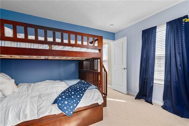 bedroom featuring baseboards and carpet flooring