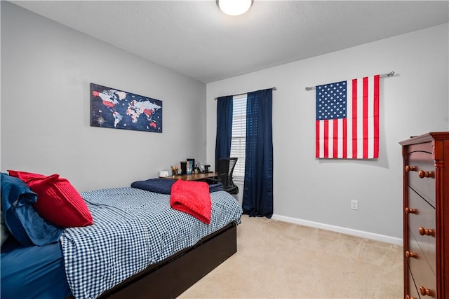 carpeted bedroom featuring baseboards