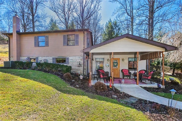 view of front facade featuring a front yard, covered porch, and a chimney