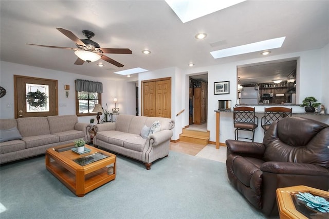 living area with recessed lighting, light carpet, a skylight, and ceiling fan