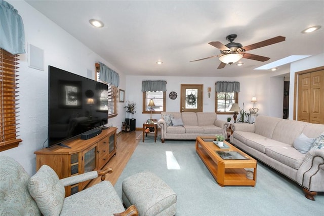 living area with recessed lighting, wood finished floors, and ceiling fan