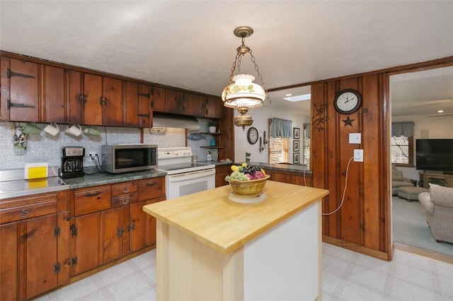 kitchen featuring white electric range, stainless steel microwave, wooden counters, and light floors