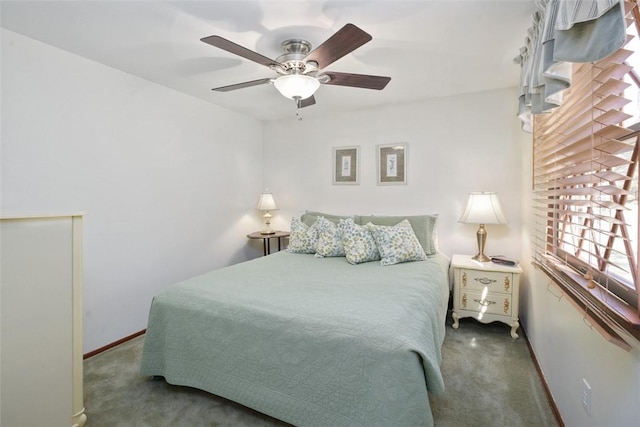 carpeted bedroom featuring a ceiling fan and baseboards