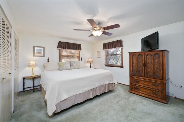 carpeted bedroom with a ceiling fan and a closet