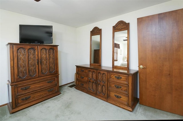 bedroom with visible vents, lofted ceiling, and light colored carpet