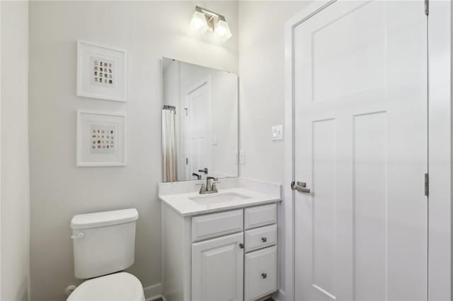 bathroom featuring toilet and vanity