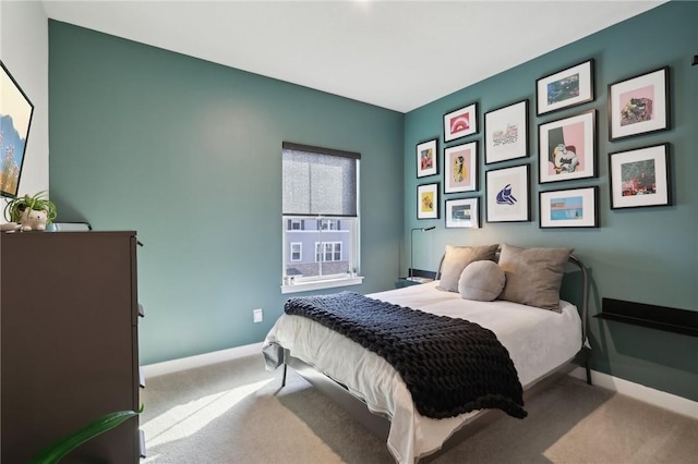 bedroom with baseboards and carpet floors