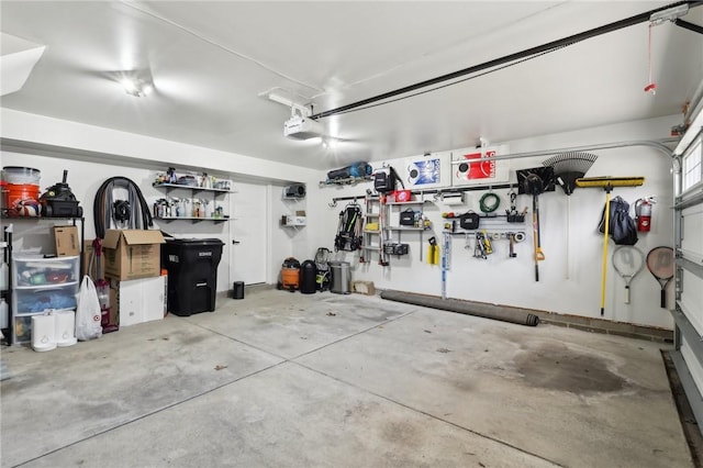 garage with a workshop area and a garage door opener