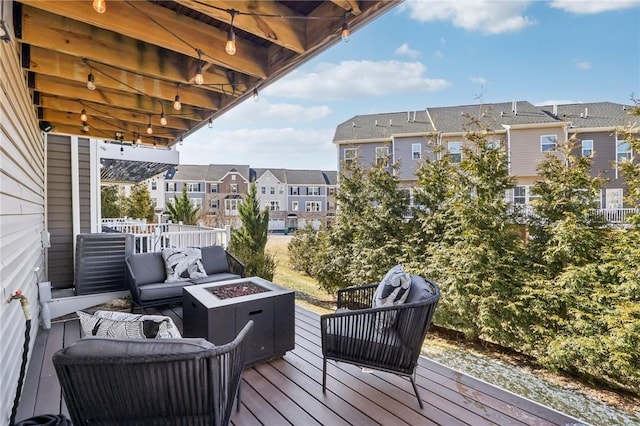 deck featuring a residential view and an outdoor living space with a fire pit