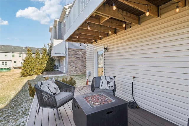 wooden deck with a fire pit