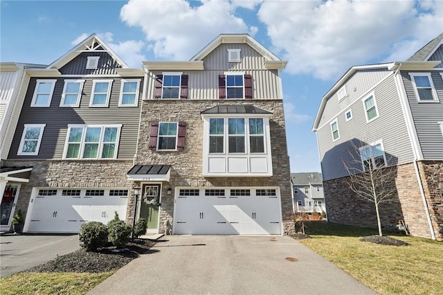 view of property featuring driveway, stone siding, board and batten siding, a front yard, and an attached garage