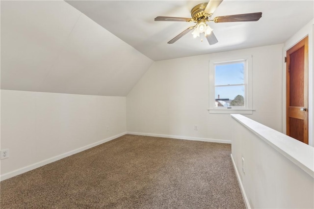 additional living space featuring vaulted ceiling, a ceiling fan, baseboards, and carpet floors