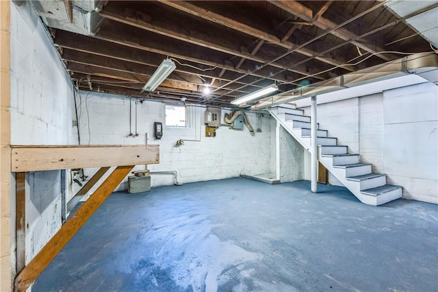 basement with stairway and electric panel