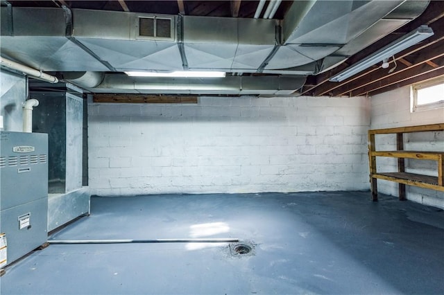 below grade area featuring visible vents and heating unit