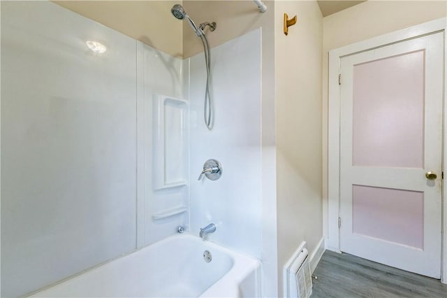 full bath featuring wood finished floors, visible vents, and shower / bath combination