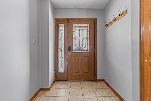 entrance foyer with light tile patterned flooring and baseboards