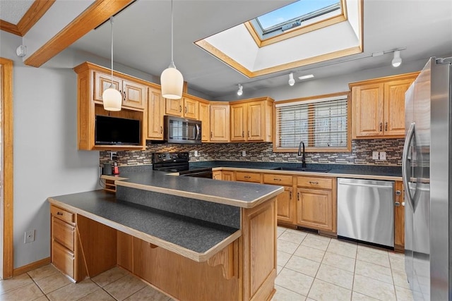 kitchen featuring dark countertops, light tile patterned floors, appliances with stainless steel finishes, a peninsula, and a sink