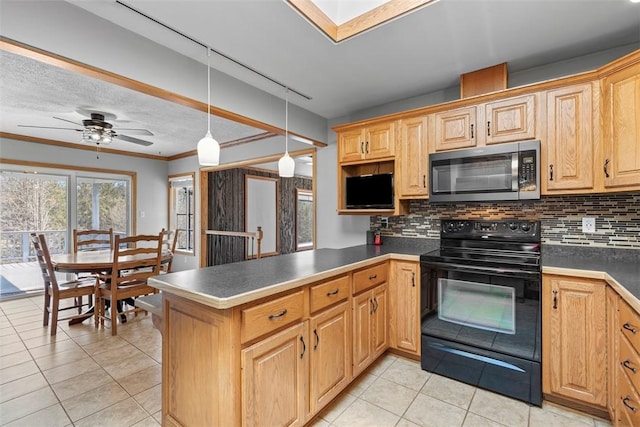 kitchen featuring pendant lighting, black range with electric stovetop, stainless steel microwave, a peninsula, and decorative backsplash