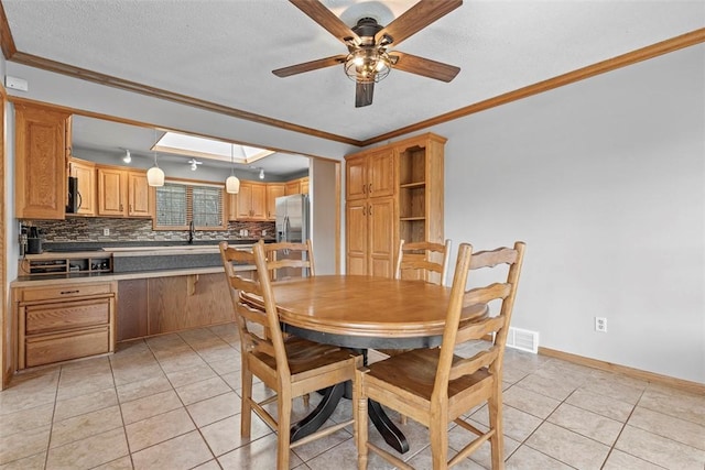 dining room with light tile patterned flooring, visible vents, and ornamental molding