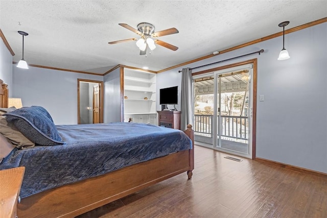 bedroom with wood finished floors, visible vents, access to exterior, a textured ceiling, and crown molding