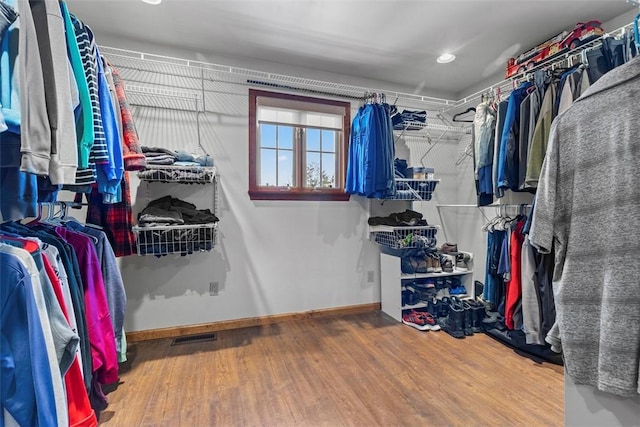 walk in closet with visible vents and wood finished floors