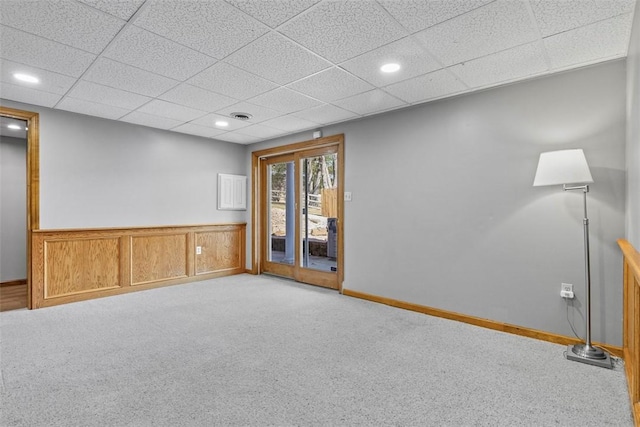 empty room featuring baseboards, visible vents, recessed lighting, a drop ceiling, and carpet flooring