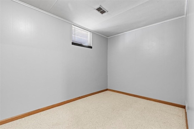 below grade area featuring baseboards, visible vents, and carpet floors