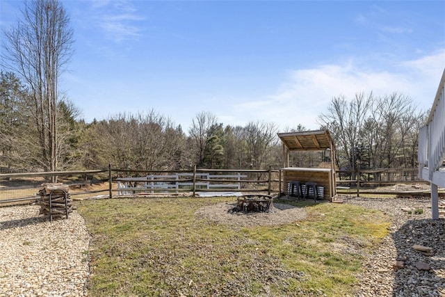 view of yard featuring an outdoor structure and fence