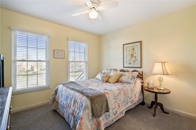 carpeted bedroom featuring baseboards and a ceiling fan