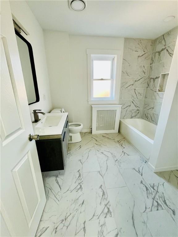 bathroom featuring toilet, marble finish floor, and vanity