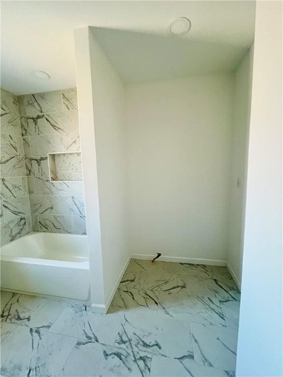 bathroom with shower / bathing tub combination, baseboards, and marble finish floor