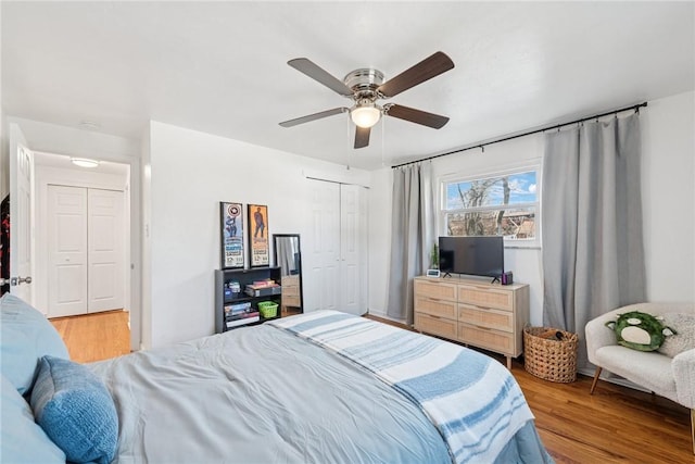 bedroom with wood finished floors, a closet, and ceiling fan