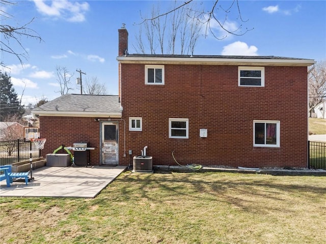 rear view of property with fence, central AC, a chimney, a yard, and a patio