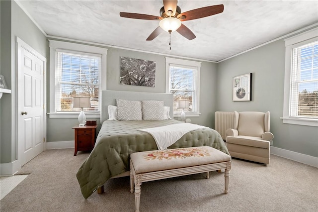 bedroom with ornamental molding, a ceiling fan, radiator heating unit, carpet, and baseboards