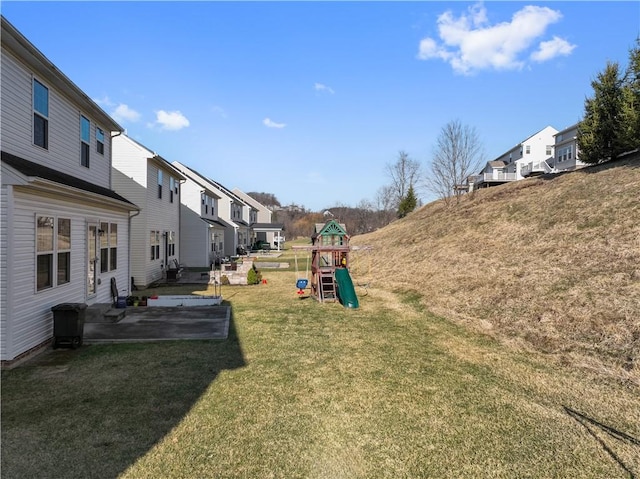 view of yard with a patio area, a residential view, and a playground